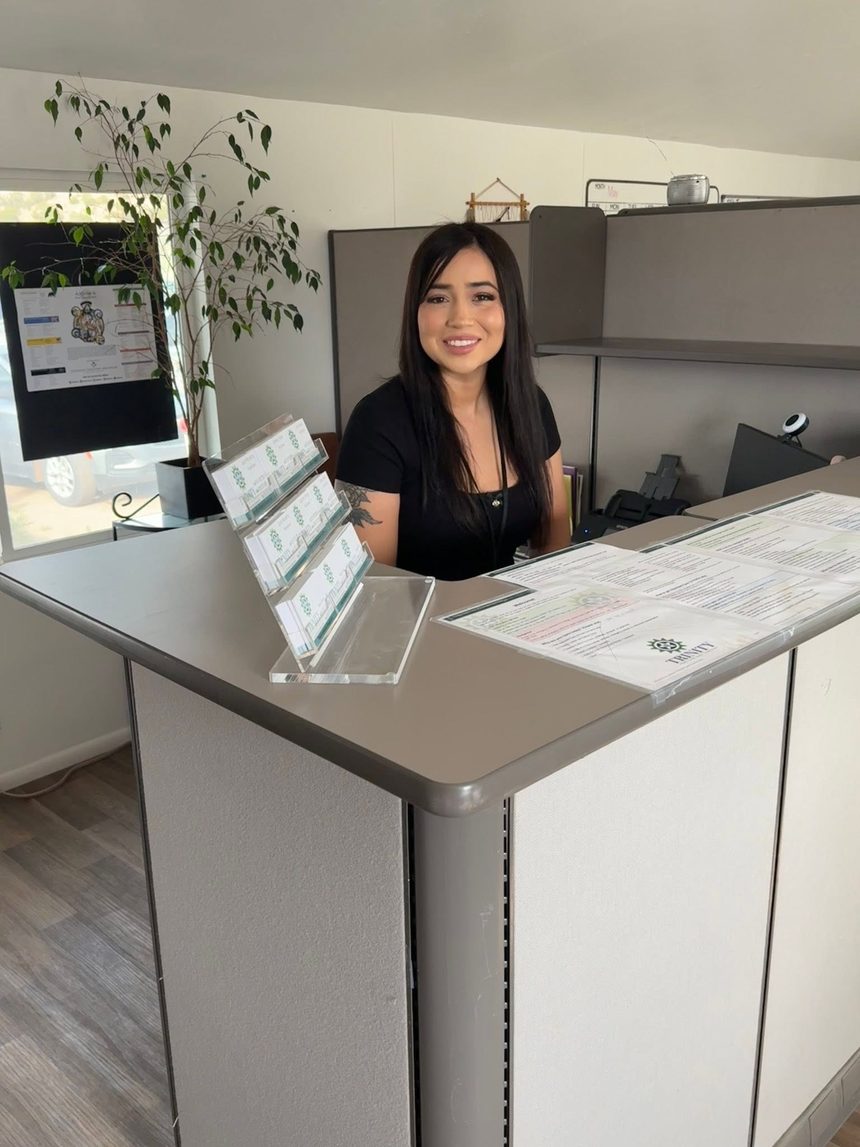 Trinity office team member welcoming visitors at the front desk