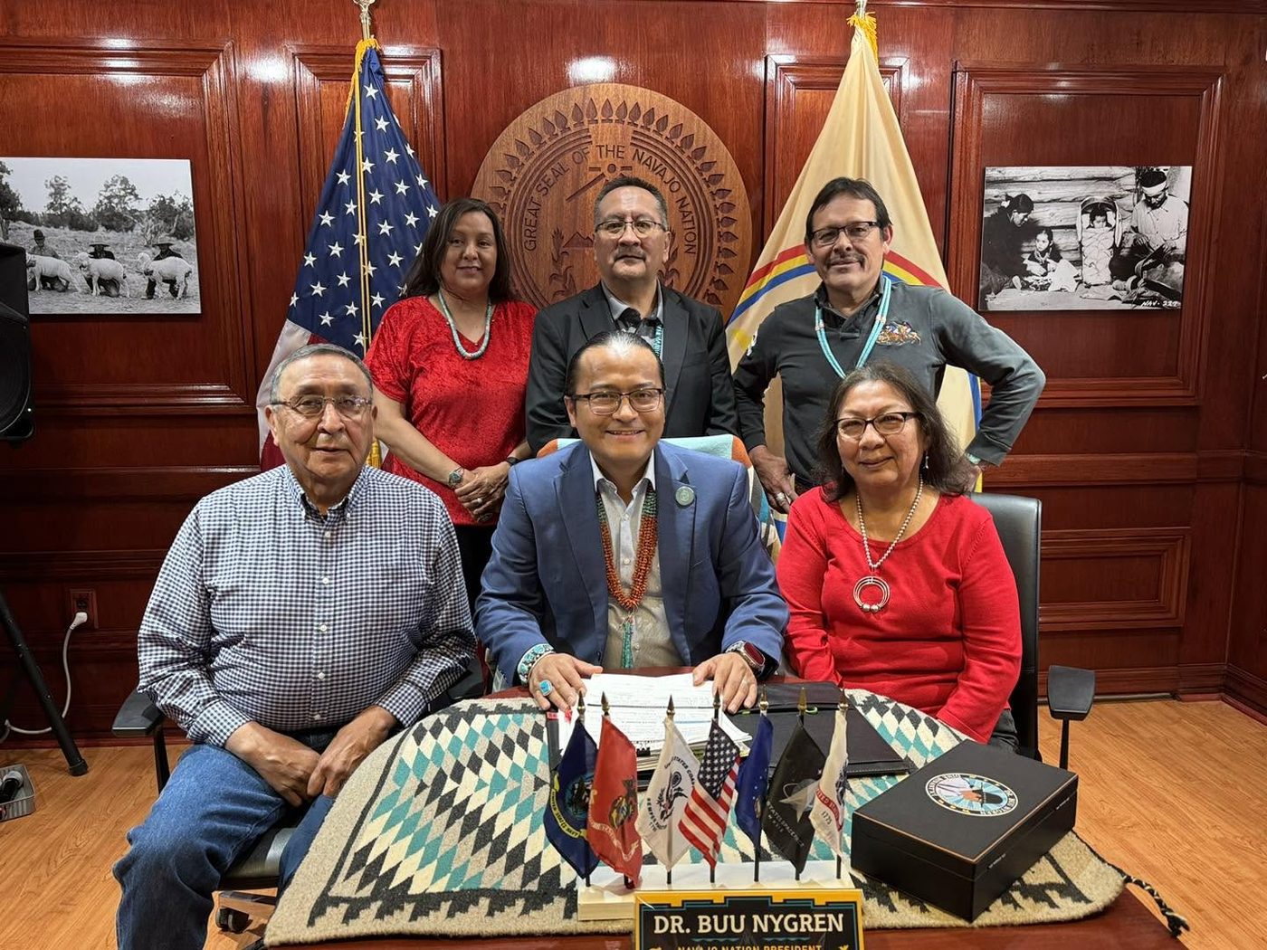 Dr. SueAnn Manuelito and her husband Arthur Manuelito seated with President Buu Nygren and staff at the business site lease signing in the Office of the President, Window Rock