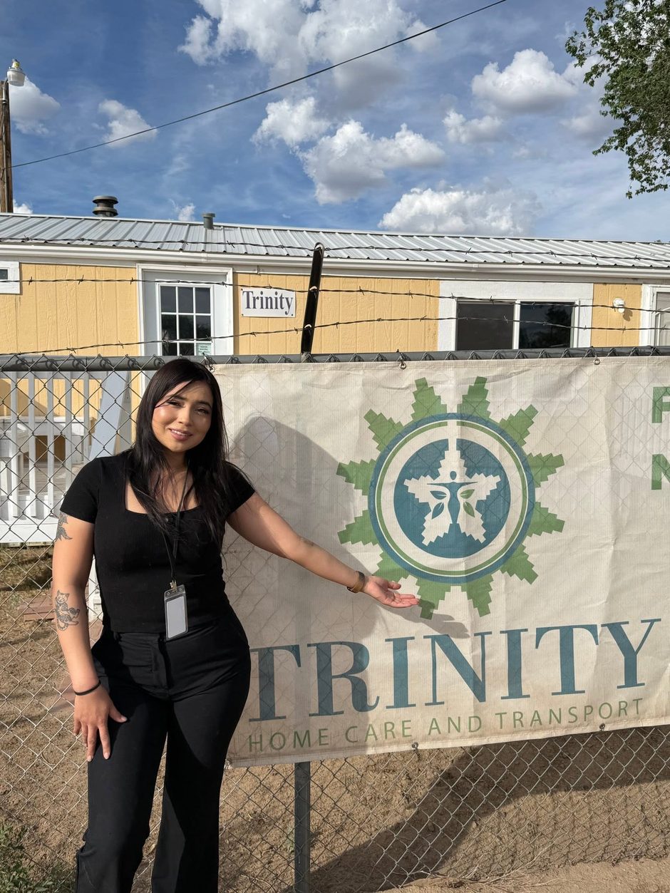 Trinity team member in front of the Trinity Home Care and Transport office in Tse Bonito