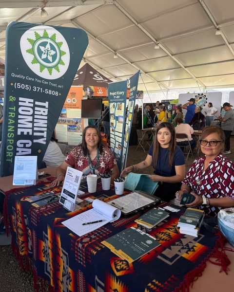 Grace Jones, Akela Scott, and Kathleen Shirley at the Trinity booth under the big tent at Elder Fest, Navajo Nation Fairgrounds
